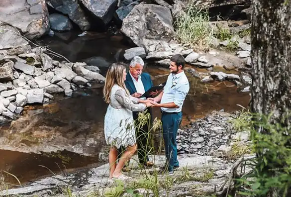 Indian couple with wedding officiant